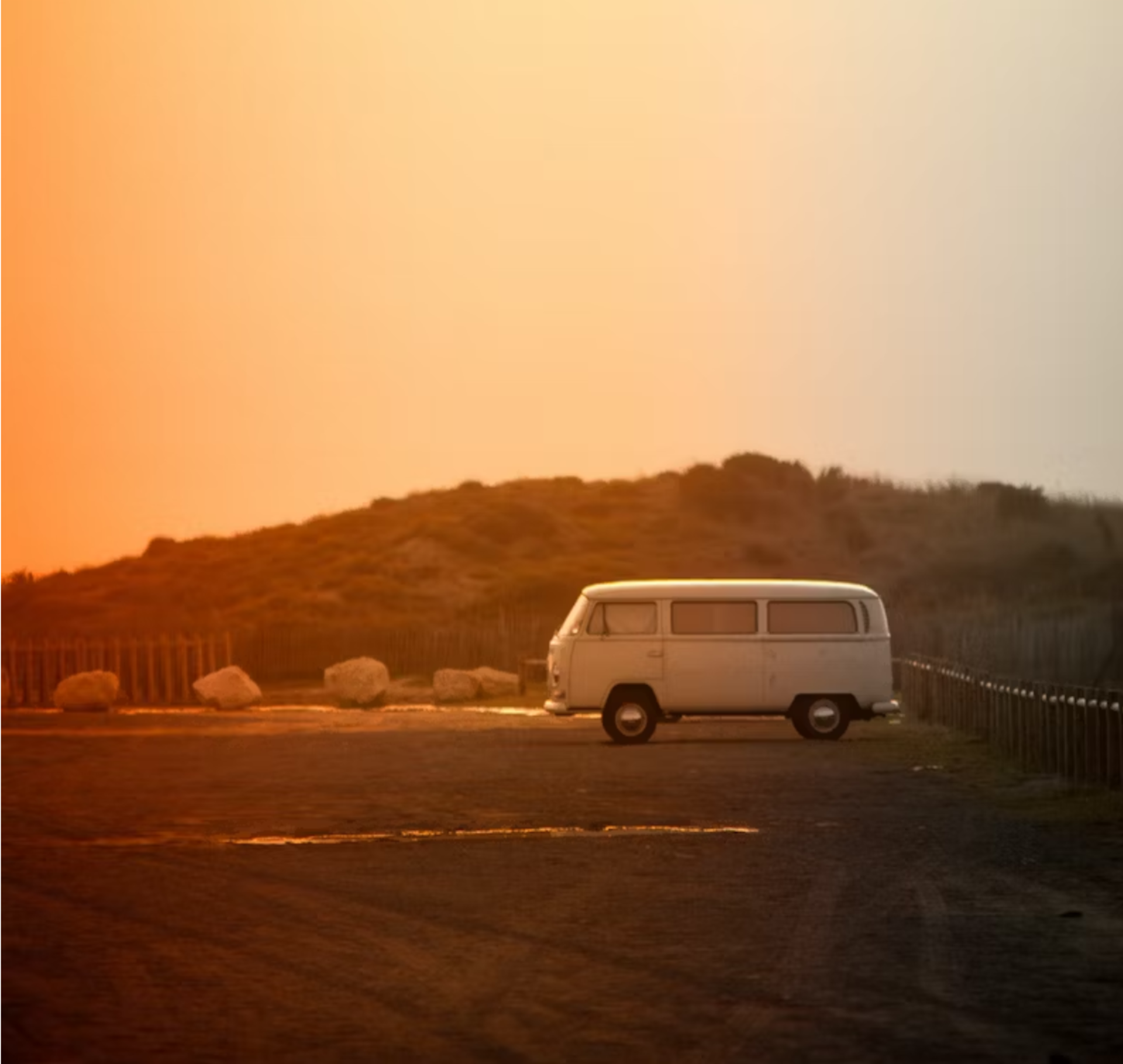 A van parking in a heat wave, with visible heat distortion in the air. The surroundings appear hazy and the heat is intense.