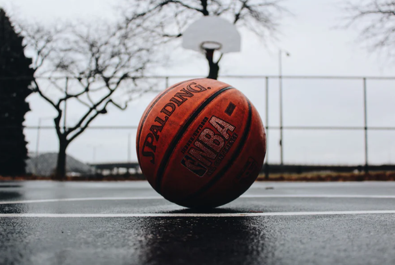 A basketball lying in the court.